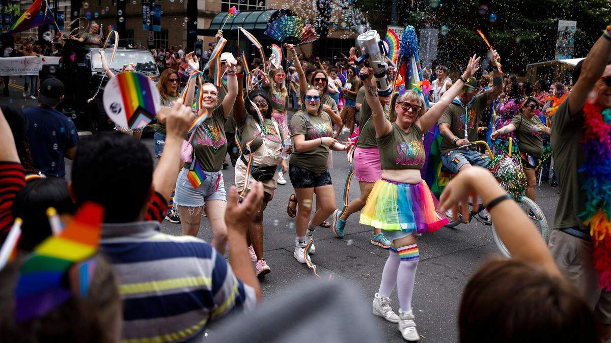Members of the Noda Company Store group interact with the crowd during the Charlotte Pride Parade through uptown, Sunday, Aug. 21, 2022. 