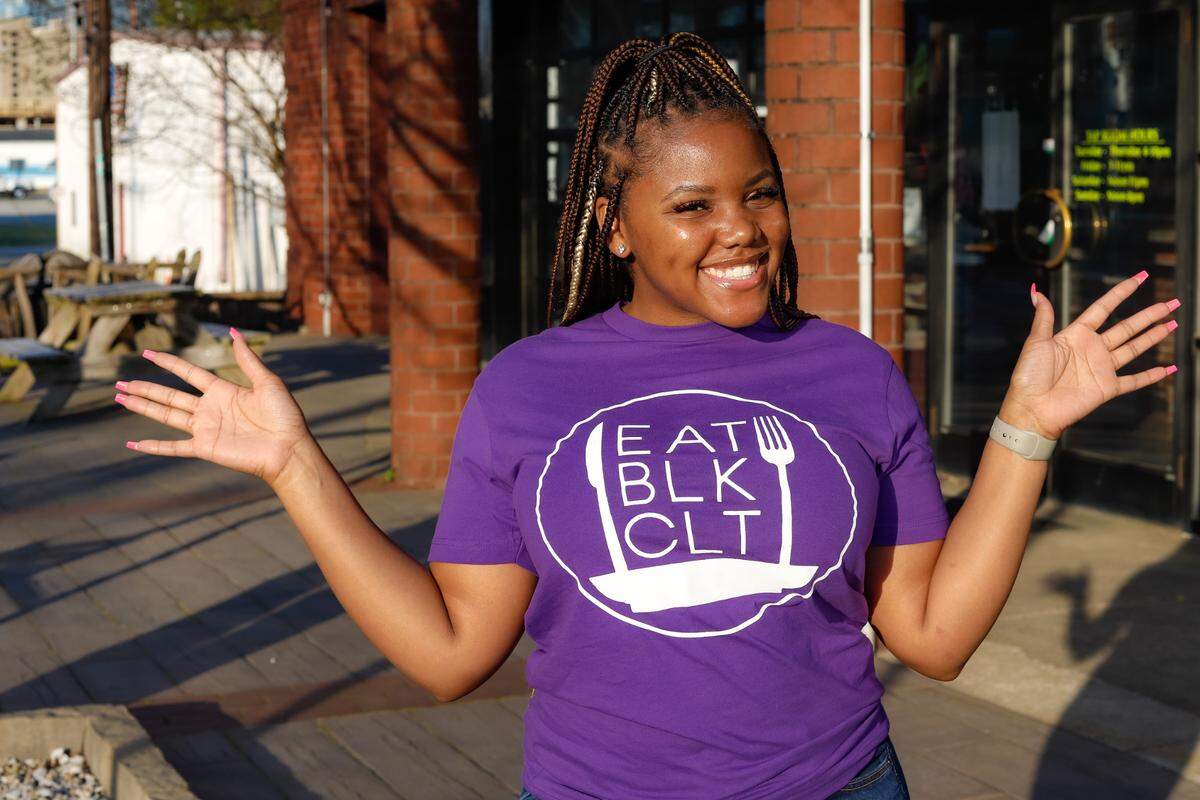 Eat Black Charlotte Week will showcase the best Black-owned food businesses in the Queen City this June. Food blogger Amber Owens sports the brand T-shirt.