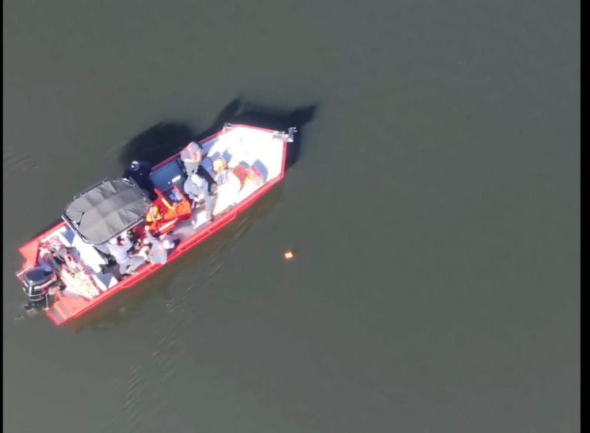 Responders on a fire boat search for a missing kayaker near Cowans Ford Dam in eastern Lincoln County.