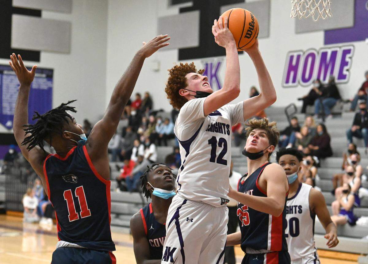 Ardrey Kell’s Brock Rose, center, drives into the lane for a shot during second half action against Covenant Day on Friday, December 10, 2021 at Ardrey Kell High School.