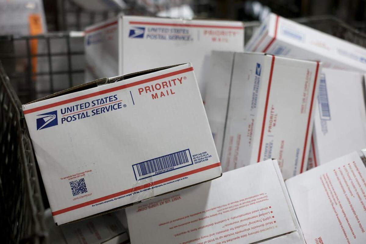 OPA-LOCKA, FLORIDA - DECEMBER 17: Packages sit in a bin as the U.S. Postal Service prepares them for delivery at the Royal Palm Processing and Distribution Center on December 17, 2024 in Opa Locka, Florida. The processing center handles about 650,00 packages every day of the week during the busy gift-giving season. December 21st is the last day to give a package to the postal service to have it delivered for Christmas. (Photo by Joe Raedle/Getty Images)