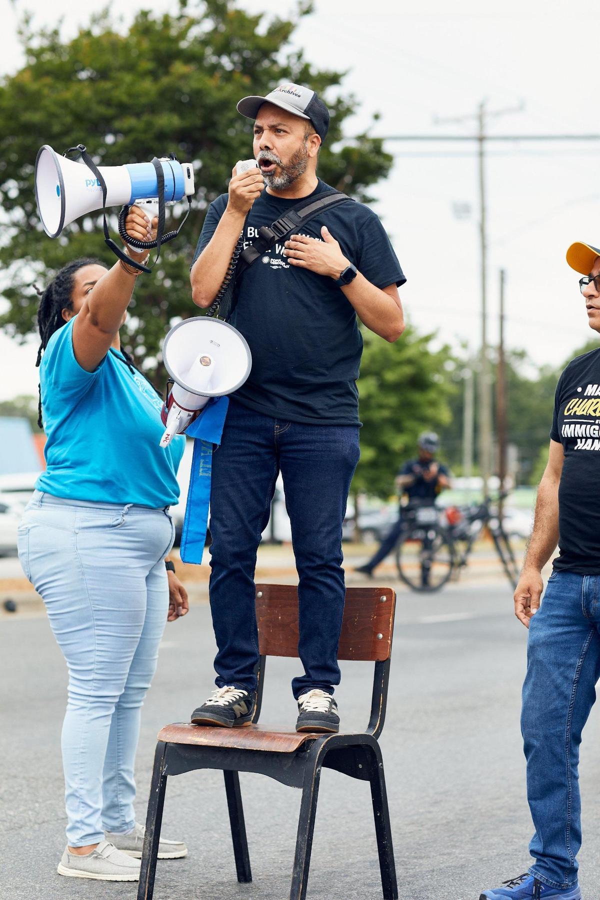 A representative of Action NC addresses the crowd on Central Avenue for the May Day Trump Protests in Charlotte, North Carolina on May 3, 2025.