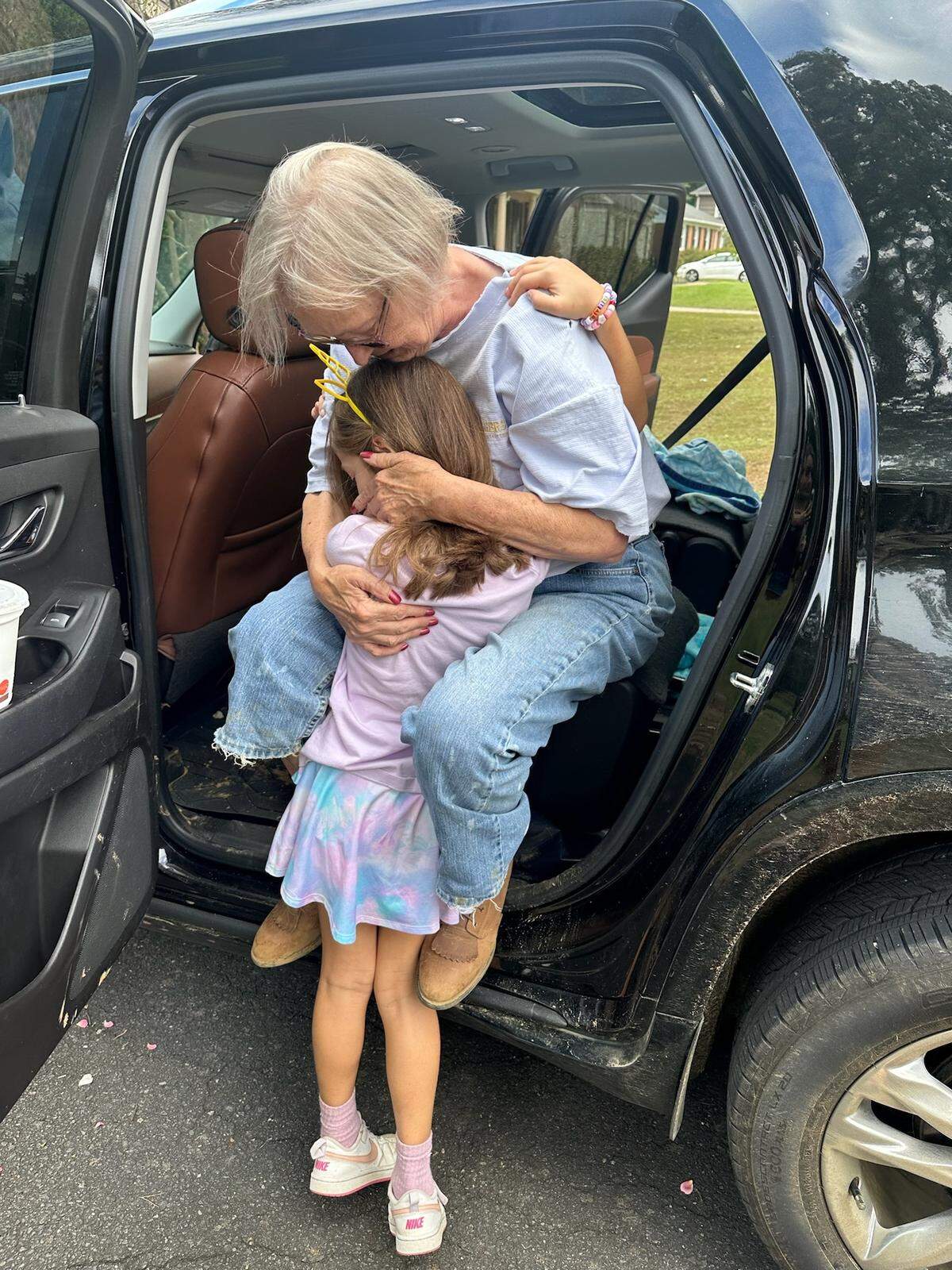 Jeannette Bledsoe hugs her great-niece Olivia back in Charlotte, after being evacuated from her home in Minneapolis, N.C.