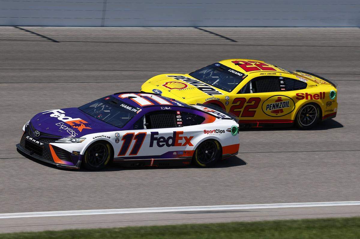 May 6, 2023; Kansas City, Kansas, USA; NASCAR Cup Series driver Denny Hamlin (11) and driver Joey Logano (22) during the Heart of America 200 at Kansas Speedway. Mandatory Credit: Mike Dinovo-USA TODAY Sports