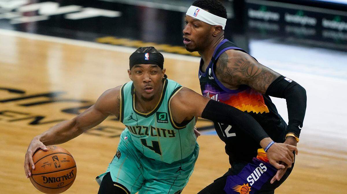 Charlotte Hornets guard Devonte Graham drives to the basket past Phoenix Suns forward Torrey Craig Sunday. Graham scored a season-high 30 points, but the Hornets lost, 101-97.