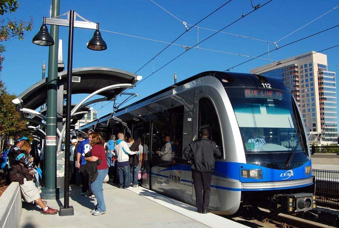 Passengers board a Blue Line light rail train in Charlotte. The train stations do no have gates or another mechanism to prevent riders from entering without a ticket.