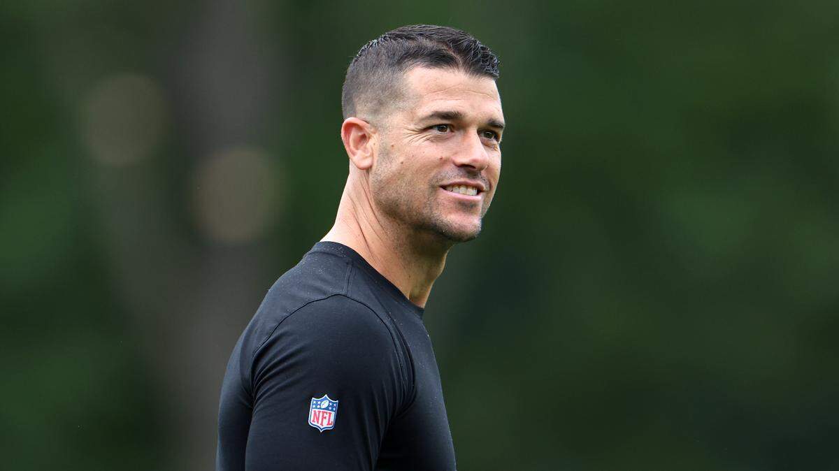 Carolina Panthers head coach Dave Canales glances toward the sidelines as he walks to training camp practice on Thursday, July 25, 2024.