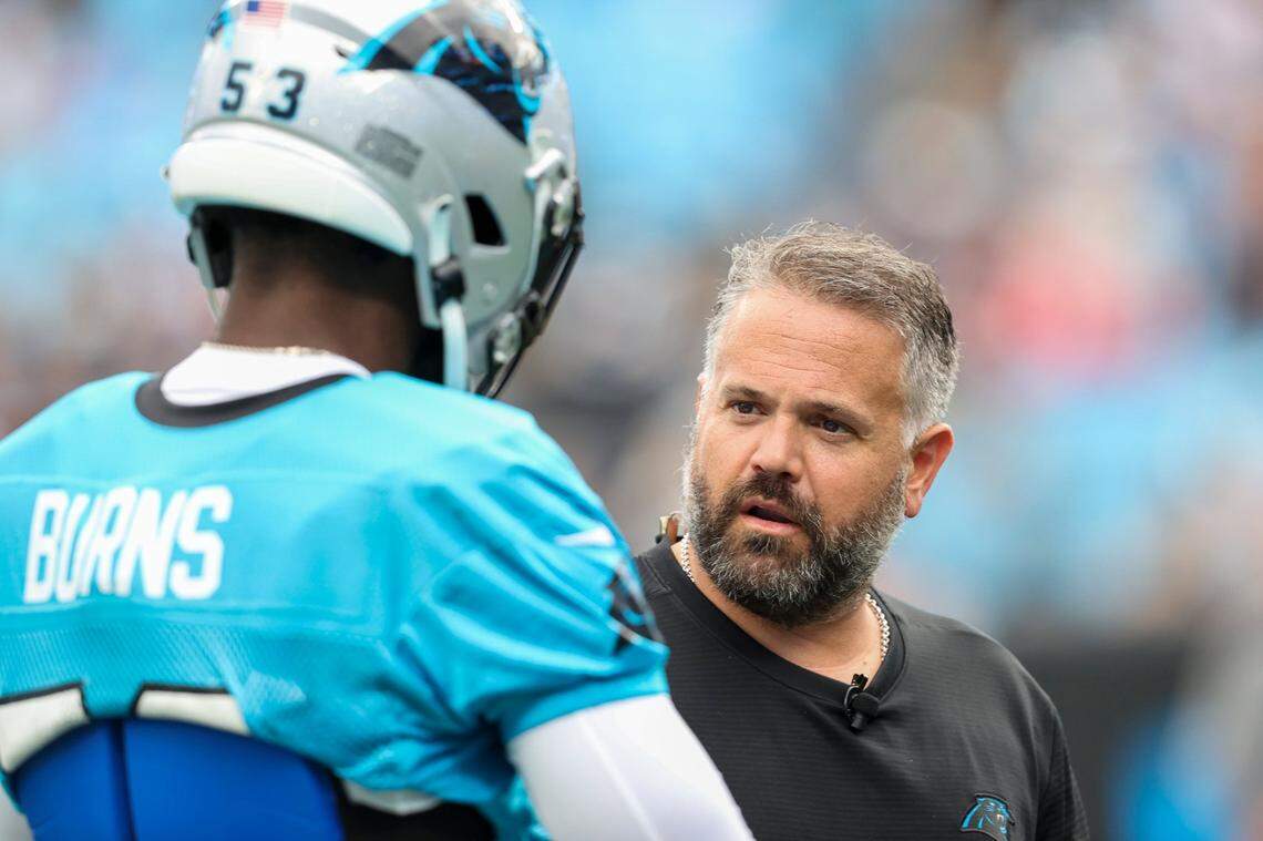 Carolina Panthers head coach Matt Rhule, right, talks to Carolina Panthers defensive end Brian Burns during a Fan Fest practice at the NFL football team’s training camp in Charlotte, N.C., Friday, Aug. 6, 2021. (AP Photo/Nell Redmond)