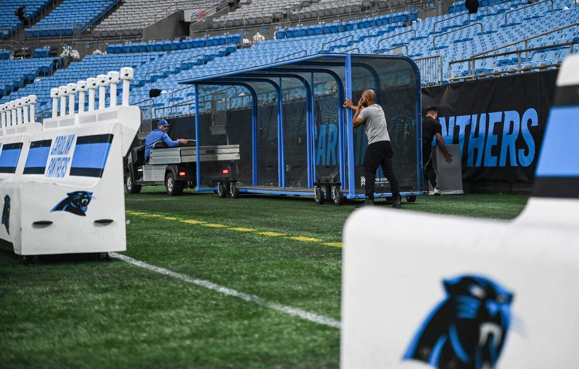 Stadium operations crews bring out shelters for MLS players as they work to transition the field from an NFL game and prepping it for an MLS game at Bank of America Stadium in Charlotte, NC on Sunday, October 26, 2025.