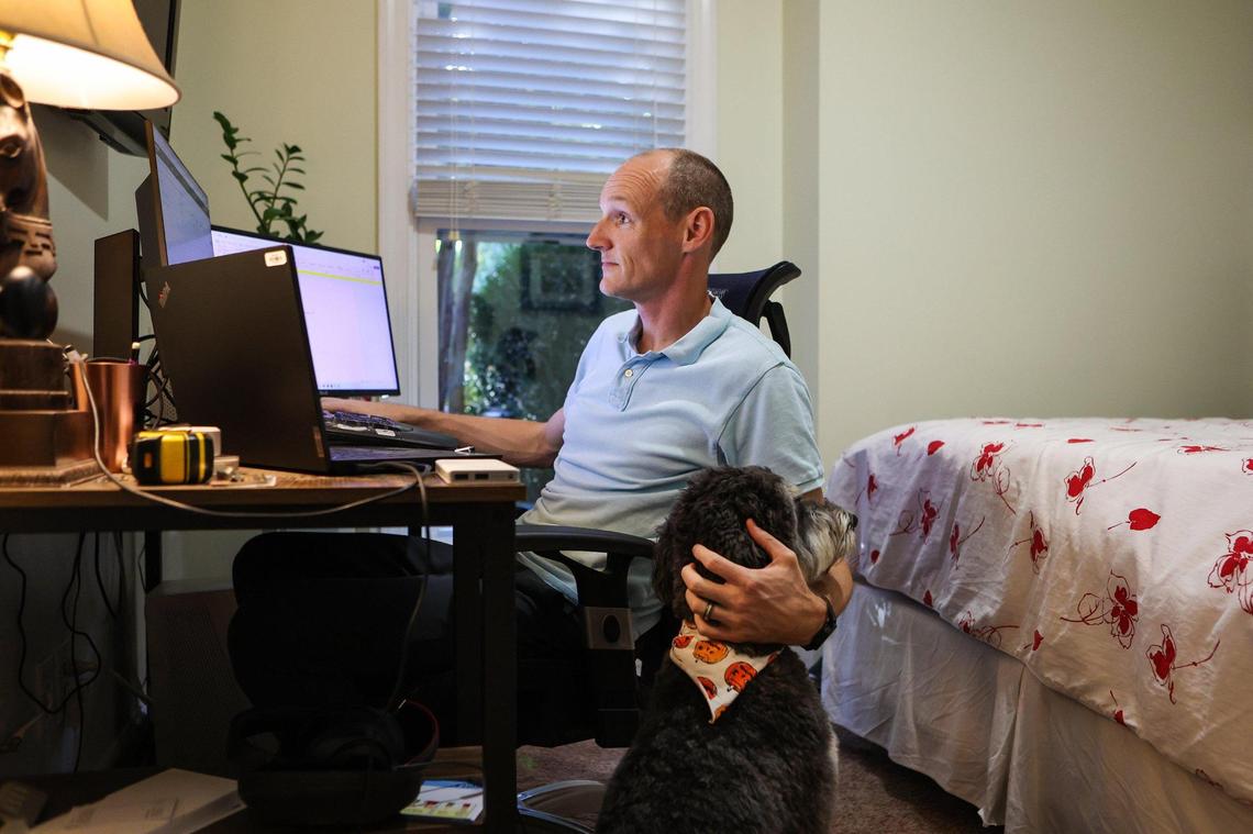 Derek May works from home full-time for a software company based in Raleigh. May and his Aussie doodle, Desi, who was adopted during the stay at home order in 2020, is his constant companion while he works out of the office that used to be a guest room in his home.