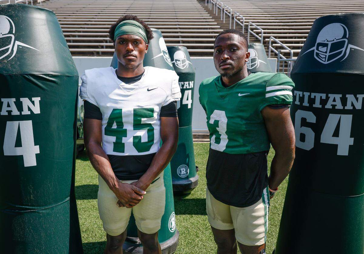UNC Charlotte defensive back Jaavan Mack, left, and his twin brother, wide receiver Jairus Mack, pose for a portrait after football practice in Charlotte, NC on Wednesday, August 28, 2024.