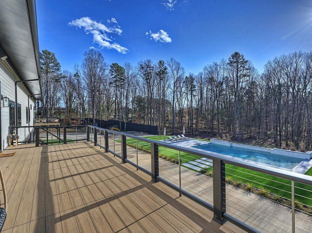Features include a private spa off the primary suite, a recently finished heated pool, and SX, MX and dirt oval tracks on the land.