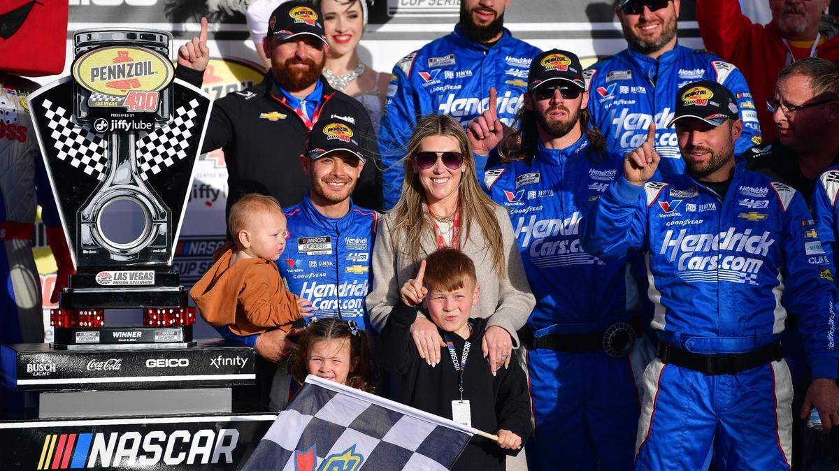 Mar 3, 2024; Las Vegas, Nevada, USA; NASCAR Cup Series driver Kyle Larson (5) poses for photos with his family and crew following his victory of the Pennzoil 400 at Las Vegas Motor Speedway. Mandatory Credit: Gary A. Vasquez-USA TODAY Sports