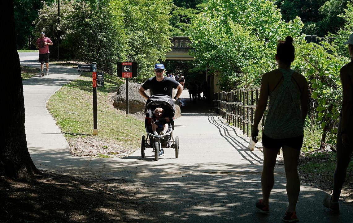 Cyclists and pedestrians share space along the Little Sugar Creek Greenway in Freedom Park in May amid COVID-19.