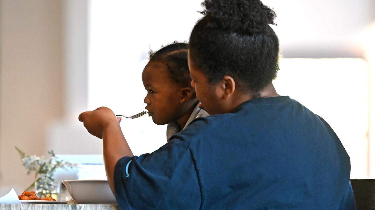 LaTonda Faggart feeds her two-year old son, Ezekiel Faggart during lunch at FeedNC in Mooresville, N.C. on Tuesday, October 24, 2023. The nonprofit provides breakfast, lunch and groceries to people in need and operates a Workforce Development Program that focuses on culinary and warehouse jobs.
