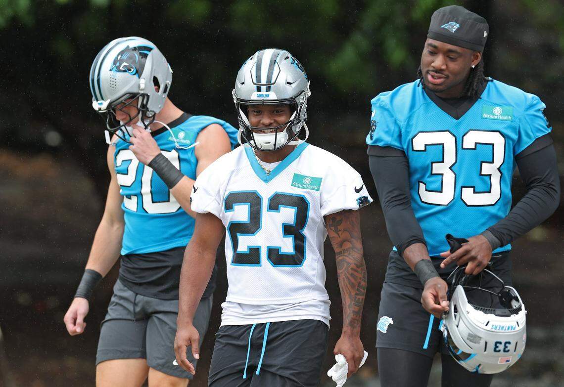 Carolina Panthers running back Trevor Etienne (center) and outside linebacker Princely Umanmielen (right) walk to the team’s OTA practice with his teammates on Tuesday, May 27, 2025. 