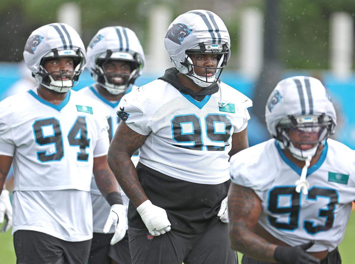 Carolina Panthers defensive tackle Cam Jackson, center, runs through a drill with his teammates during the team's first open workout on Tuesday, May 26, 2026.