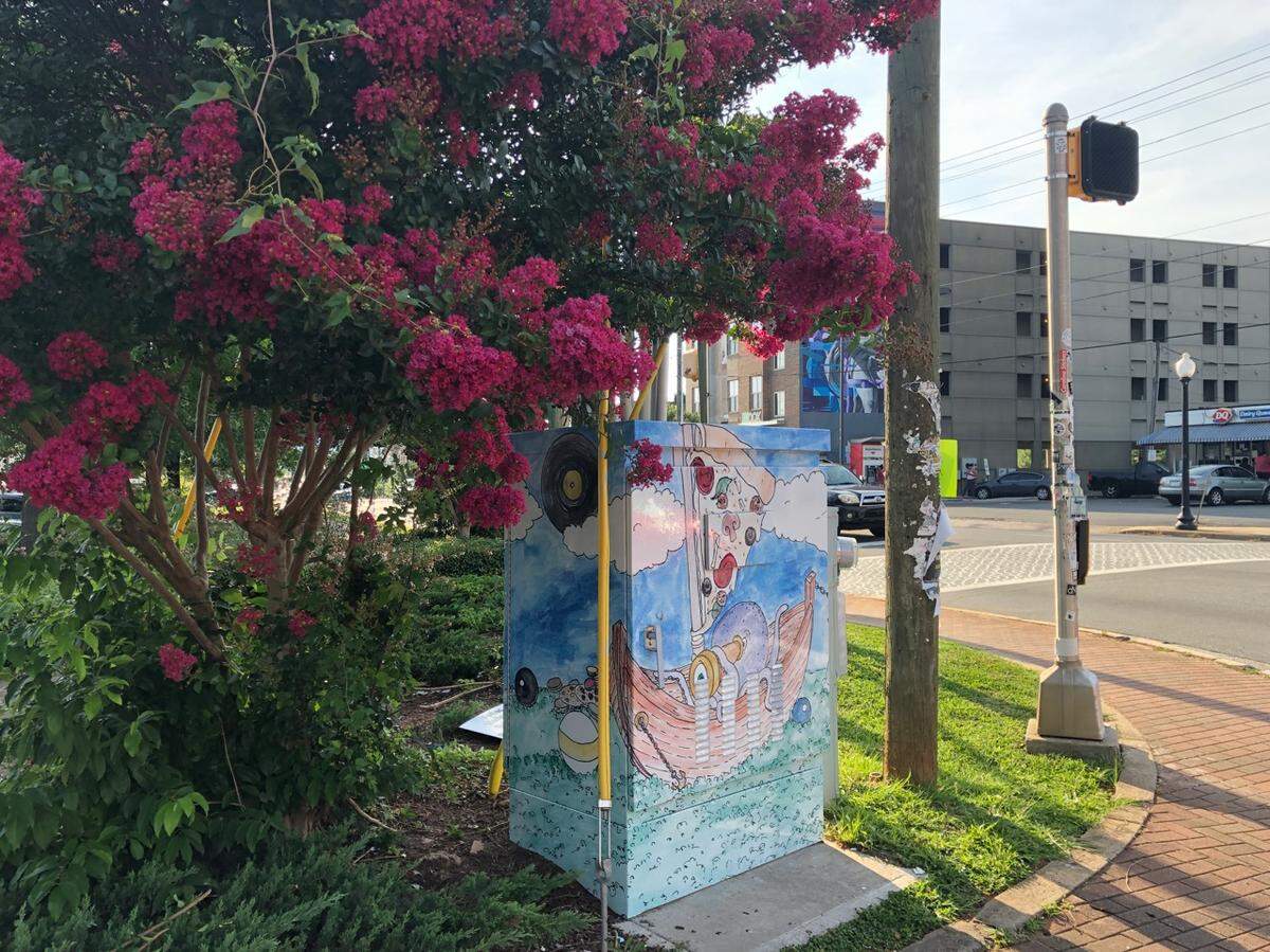 Local artist and Plaza Midwood resident Melissa Wineman submitted “Adventures in the Hood” for the signal box wrap project that depicts a whimsical fantasy world full of references to iconic neighborhood businesses. It can be found at Central Avenue and Pecan Avenue.