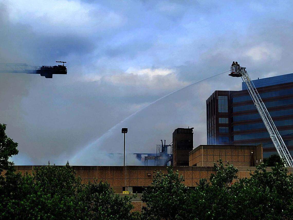 Fire fighters work the scene at a fire in Charlotte’s South Park neighborhood Thursday morning.