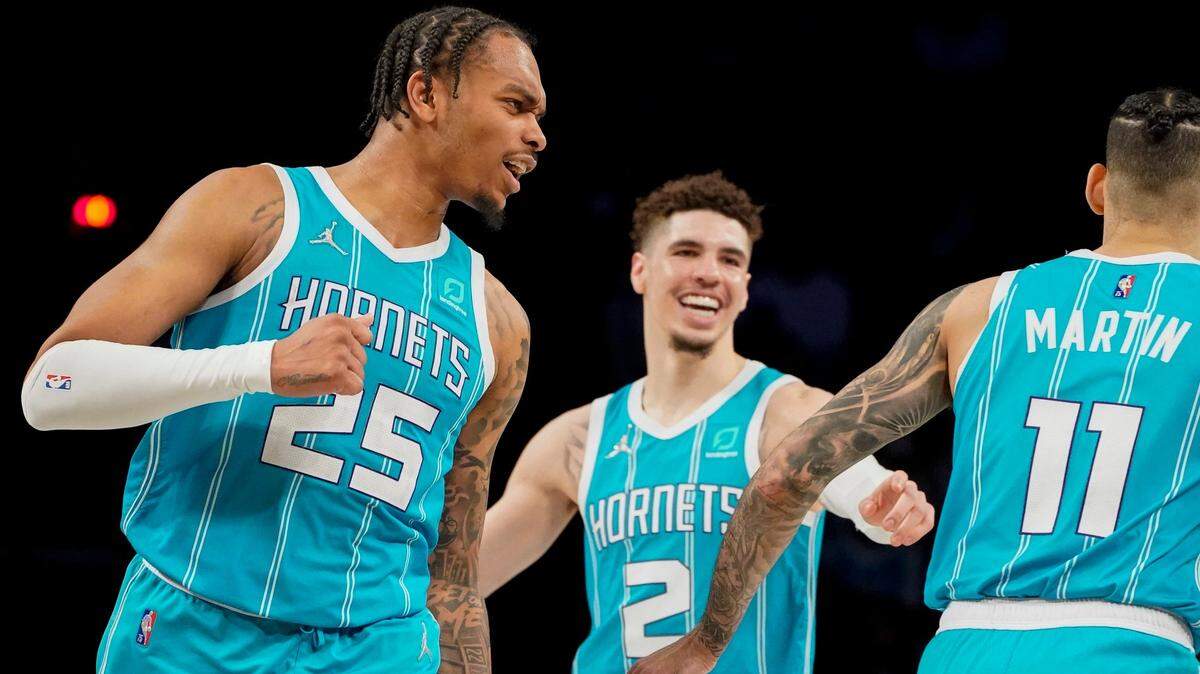 Charlotte Hornets forward P.J. Washington (25) celebrates after forward Cody Martin (11) scores in the second half of an NBA basketball game against the Brooklyn Nets, Sunday, March 27, 2022, in New York. (AP Photo/John Minchillo)