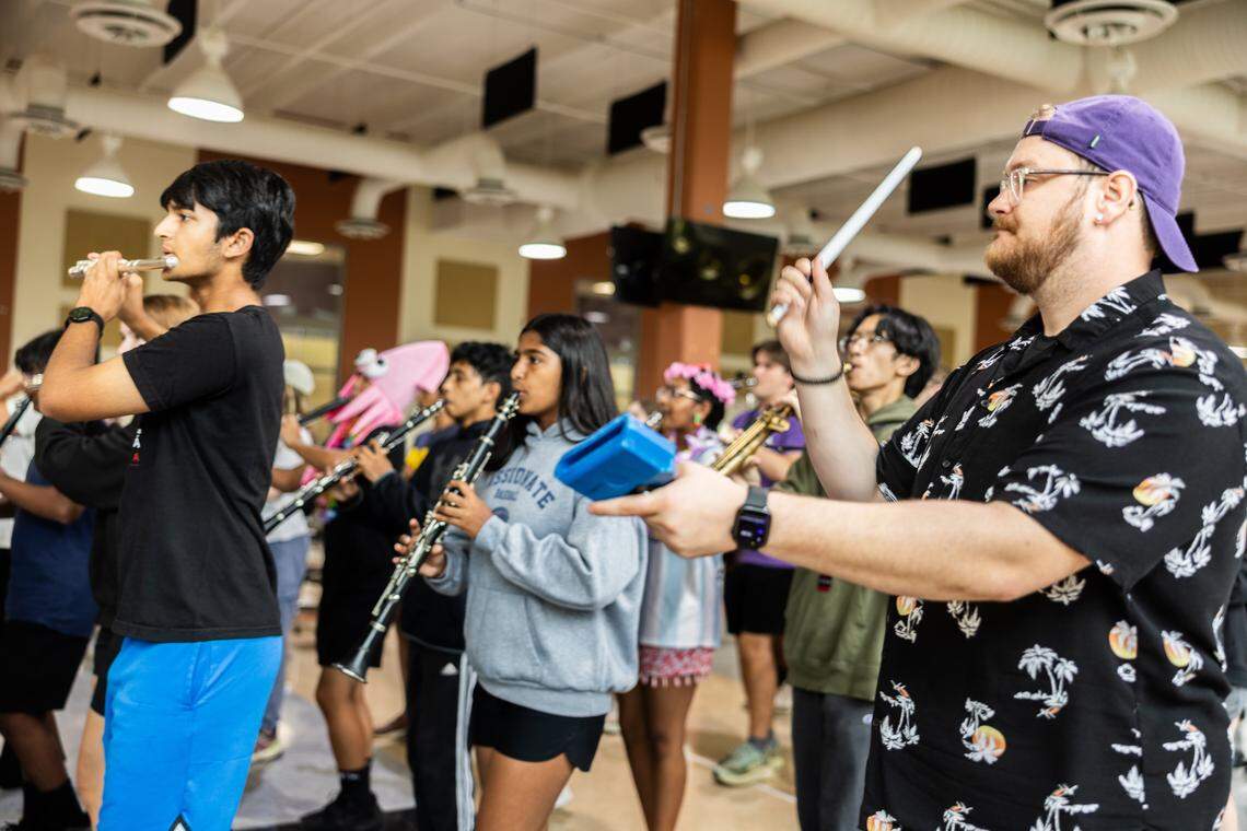 Ardrey Kell's band director leads marching band practice during band camp at Ardrey Kell High School in Charlotte, N.C., on Wednesday, August 6, 2025.