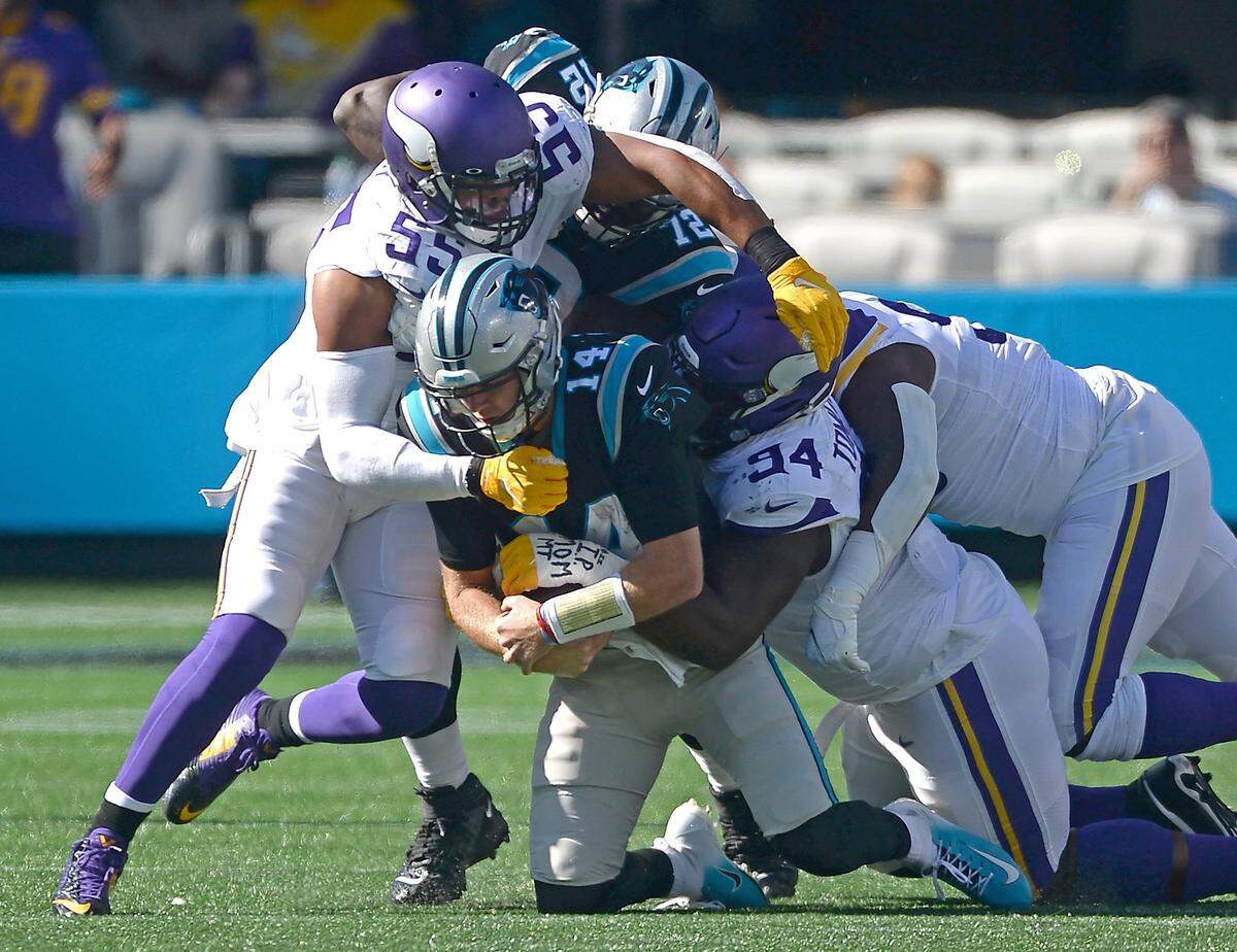 Carolina Panthers quarterback Sam Darnold, center, is sacked by Minnesota Vikings linebacker Anthony Barr, left and defensive tackle Everson Griffen, right, during third quarter action at Bank of America Stadium in Charlotte, NC on Sunday, October 17, 2021. The Vikings defeated the Panthers 34-28.