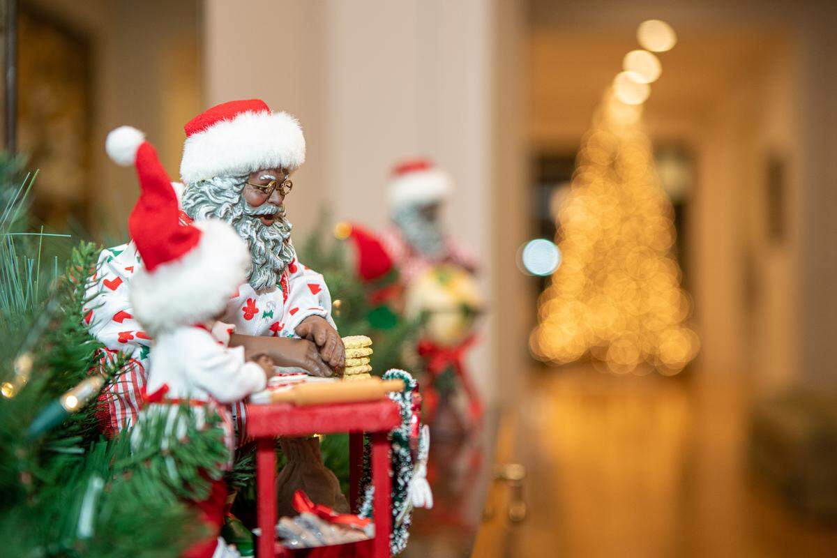 The Alston Residence on Pine Street features Santas on a side table in the foyer.