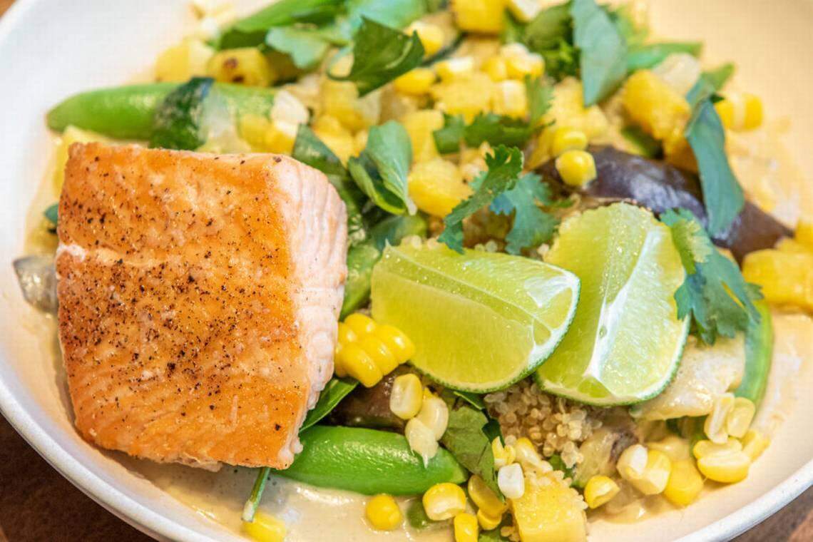 Spicy Coconut Curry, shown here with salmon, is a seasonal dish at Flower Child.