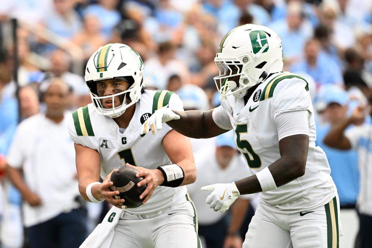 Sep 7, 2024; Chapel Hill, North Carolina, USA; Charlotte 49ers quarterback Max Brown (1) fakes a hand off to running back Cartevious Norton (5) in the 1st quarter at Kenan Memorial Stadium.