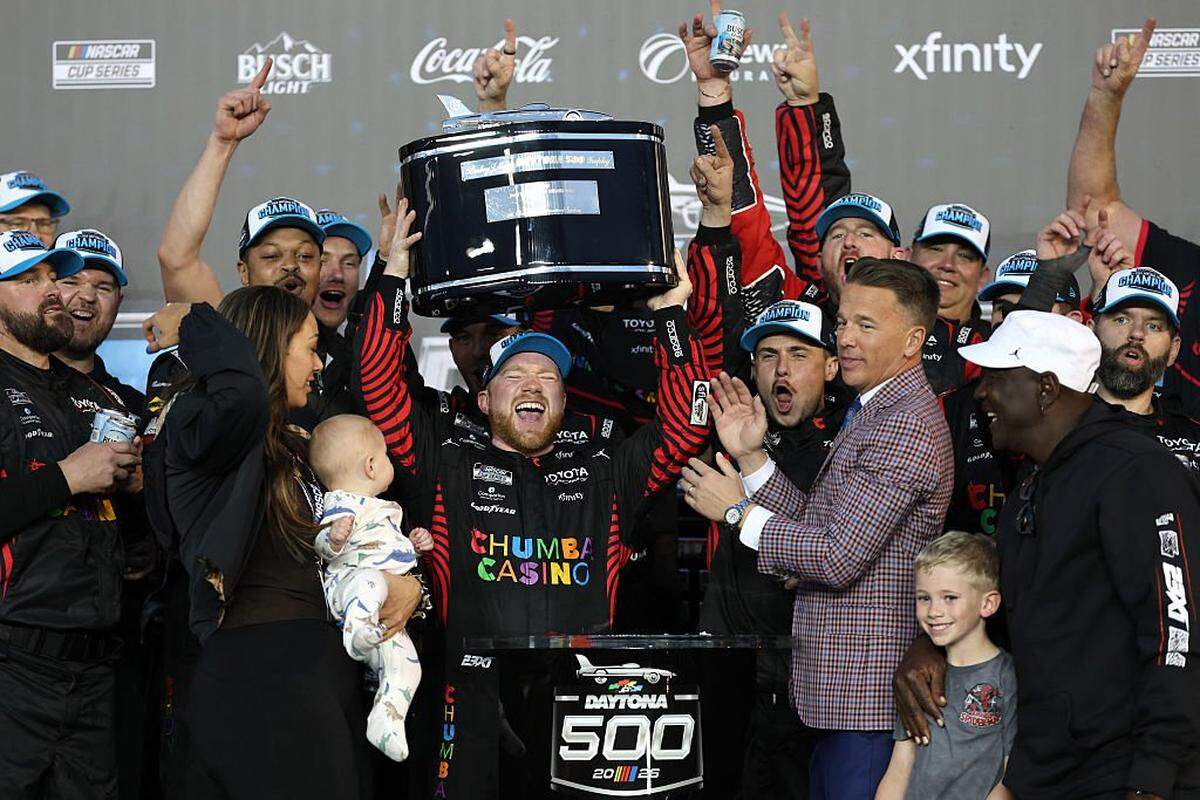 DAYTONA BEACH, FLORIDA - FEBRUARY 15: Tyler Reddick, driver of the #45 Chumba Casino Toyota, lifts the Harley J. Earl Trophy in victory lane after winning the NASCAR Cup Series Daytona 500 at Daytona International Speedway on February 15, 2026 in Daytona Beach, Florida. (Photo by Chris Graythen/Getty Images)