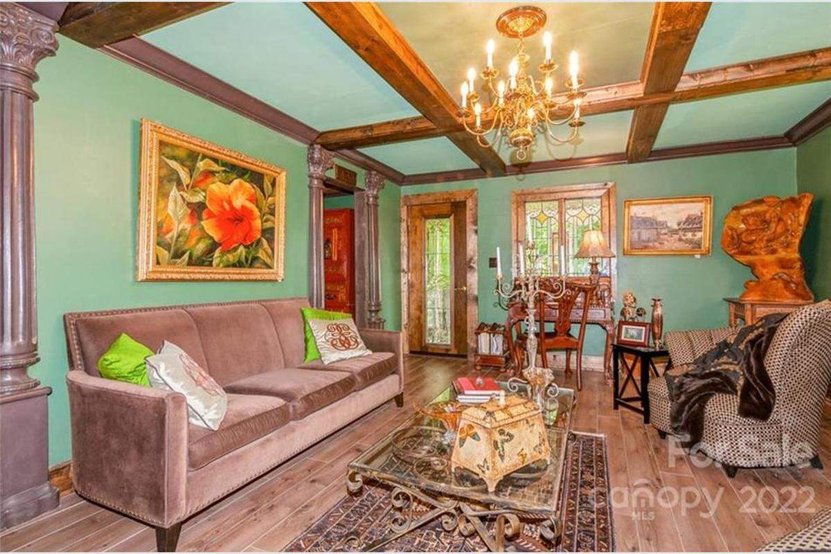 Rooms include chandeliers, green stained glass and artwork.