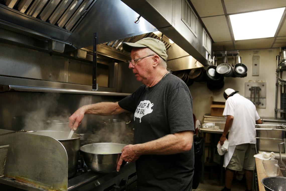 Former Crook’s Corner Bill Smith works in the kitchen at Crook’s Corner in Chapel Hill on Thursday, Oct. 4, 2018.