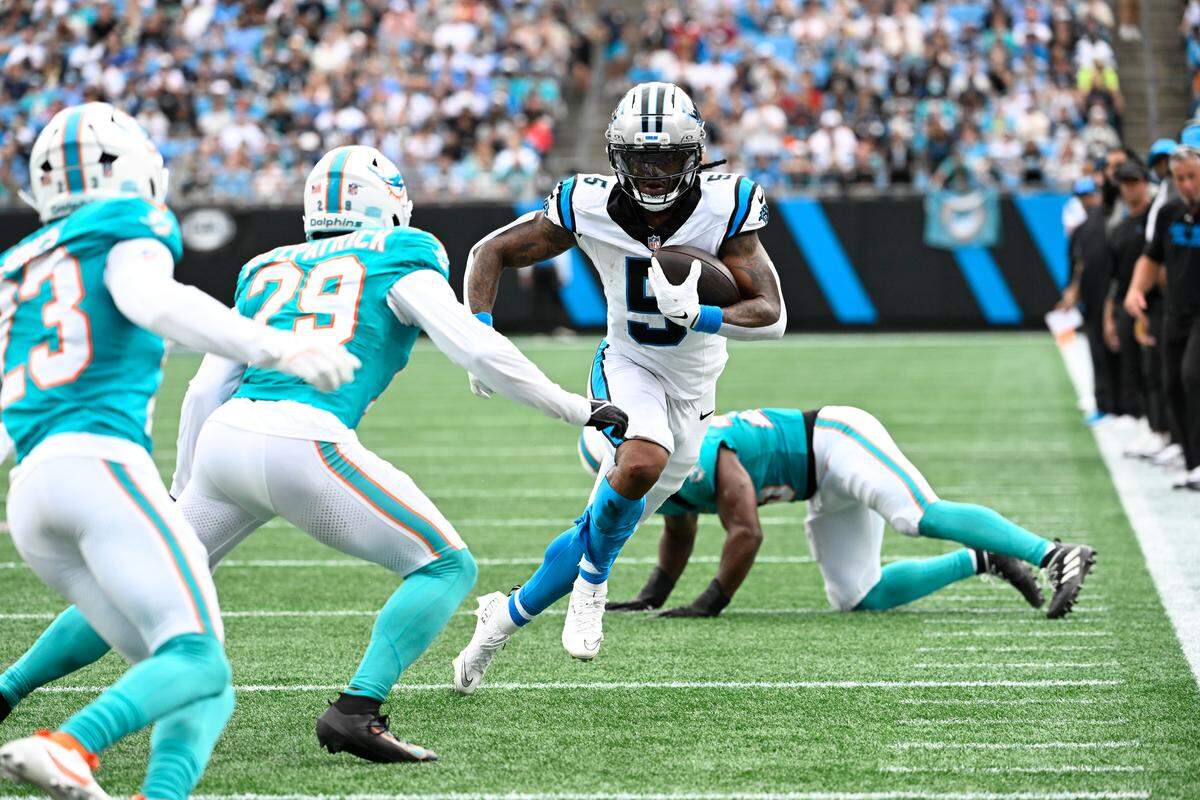 Carolina Panthers running back Rico Dowdle (5) with the ball as Miami Dolphins free safety Minkah Fitzpatrick (29) defends in Sunday’s second quarter at Bank of America Stadium. 