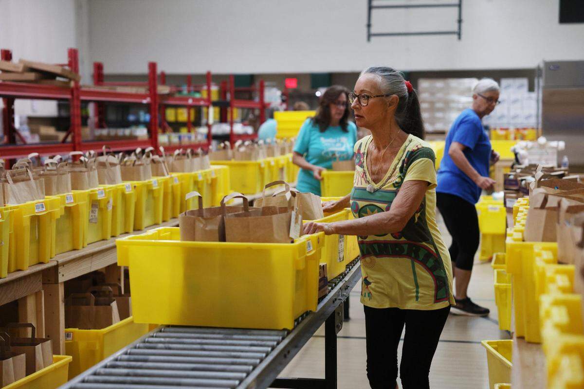 Linda Greenwald loads bags with groceries Monday, July 21, 2025 at HOPE in Rock Hill, S.C. Following recent federal funding cuts of $500 million to USDA food assistance programs, ordered by the Trump administration through its 2026 budget plan, could see an increase in demand, said Director Gordon Bell.