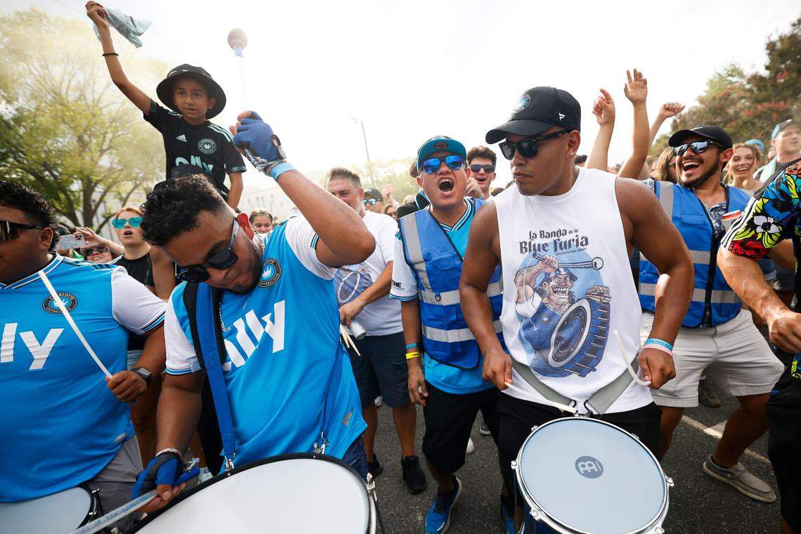Charlotte FC fans march along Stadium View Drive on their way to the match between Charlotte FC and Columbus Crew at Bank of America Stadium in Charlotte, N.C., Saturday, July 30, 2022.
