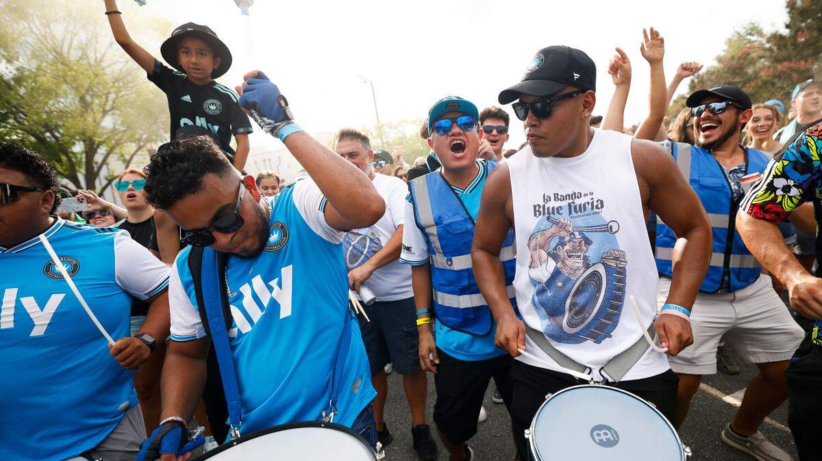 Charlotte FC fans march along Stadium View Drive on their way to the match between Charlotte FC and Columbus Crew at Bank of America Stadium in Charlotte, N.C., Saturday, July 30, 2022.