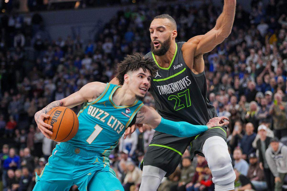 Charlotte Hornets guard LaMelo Ball (1) dribbles against Minnesota Timberwolves center Rudy Gobert (27) in the fourth quarter at Target Center.