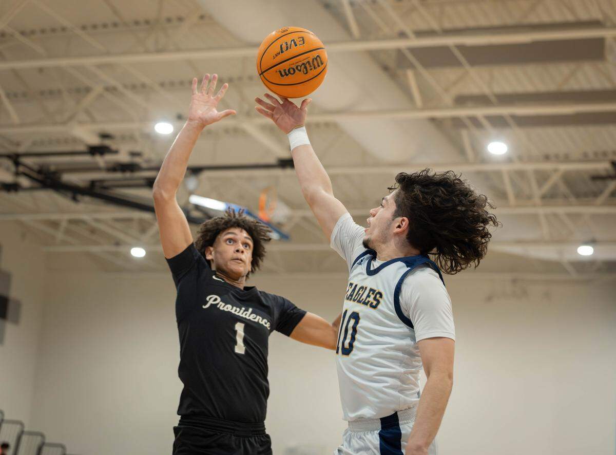 Providence's Liam Drayton (1) blocks the shot of East Meck's Ian Ramirez Toro (10). East Meck would play Providence in the Southwestern conference tournment championship at Ballantyne Ridge Friday February 20, 2026.