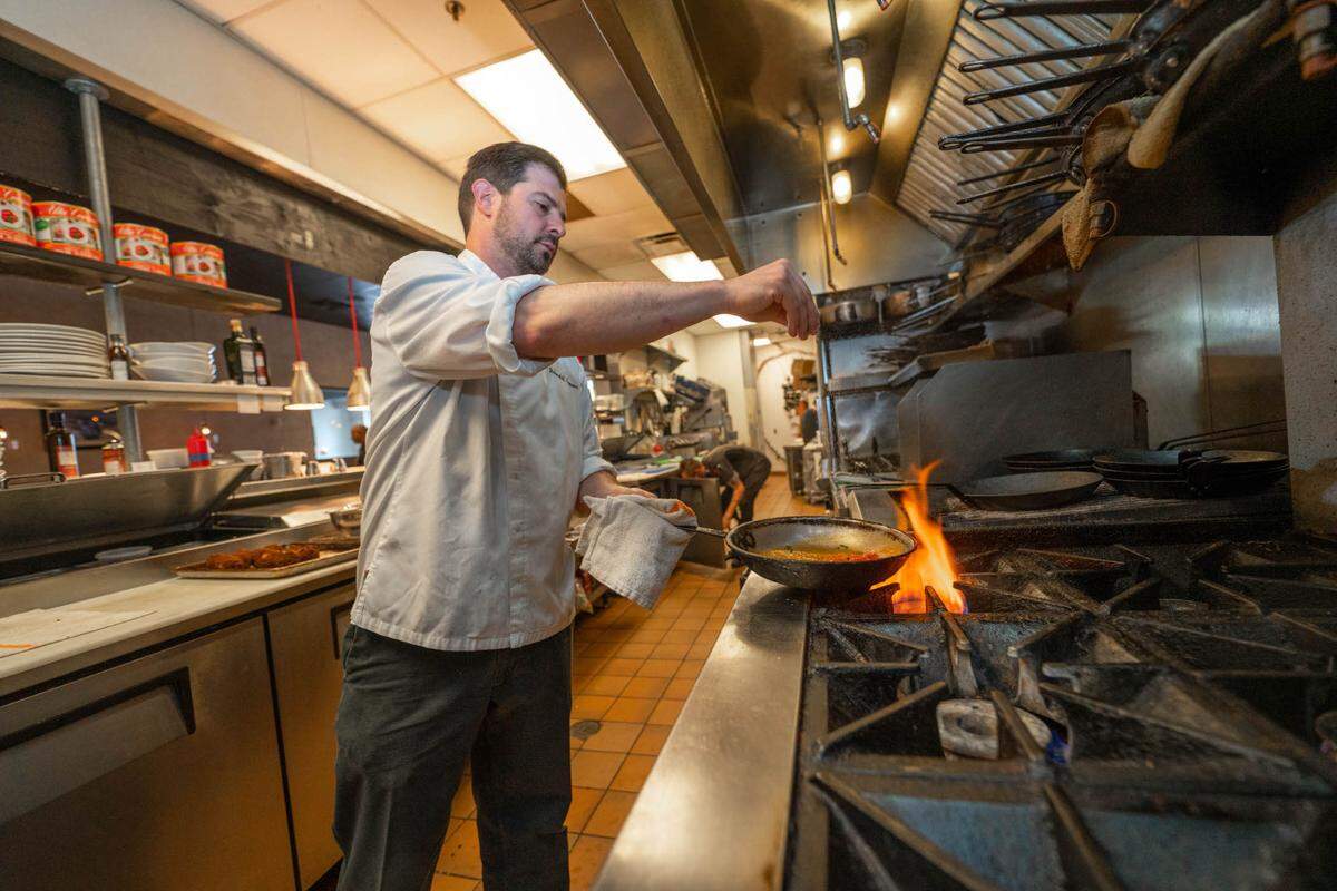 Chef Richard Cranmer in the sauté area of the kitchen at Zinicola Italian Restaurant in Ballantyne.