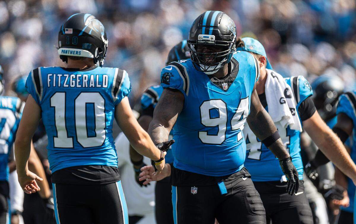 Carolina Panthers defensive end A'Shawn Robinson, right, celebrates with teammate Ryan Fitzgerald during a 2025 game in Charlotte. 