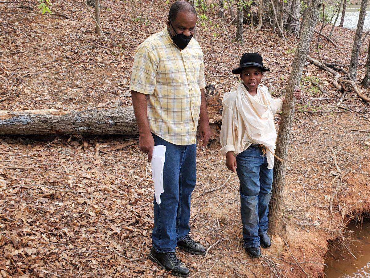 Charlotte filmmaker Ronald Dolphus works on set with actor Aidan Wallace, 12.