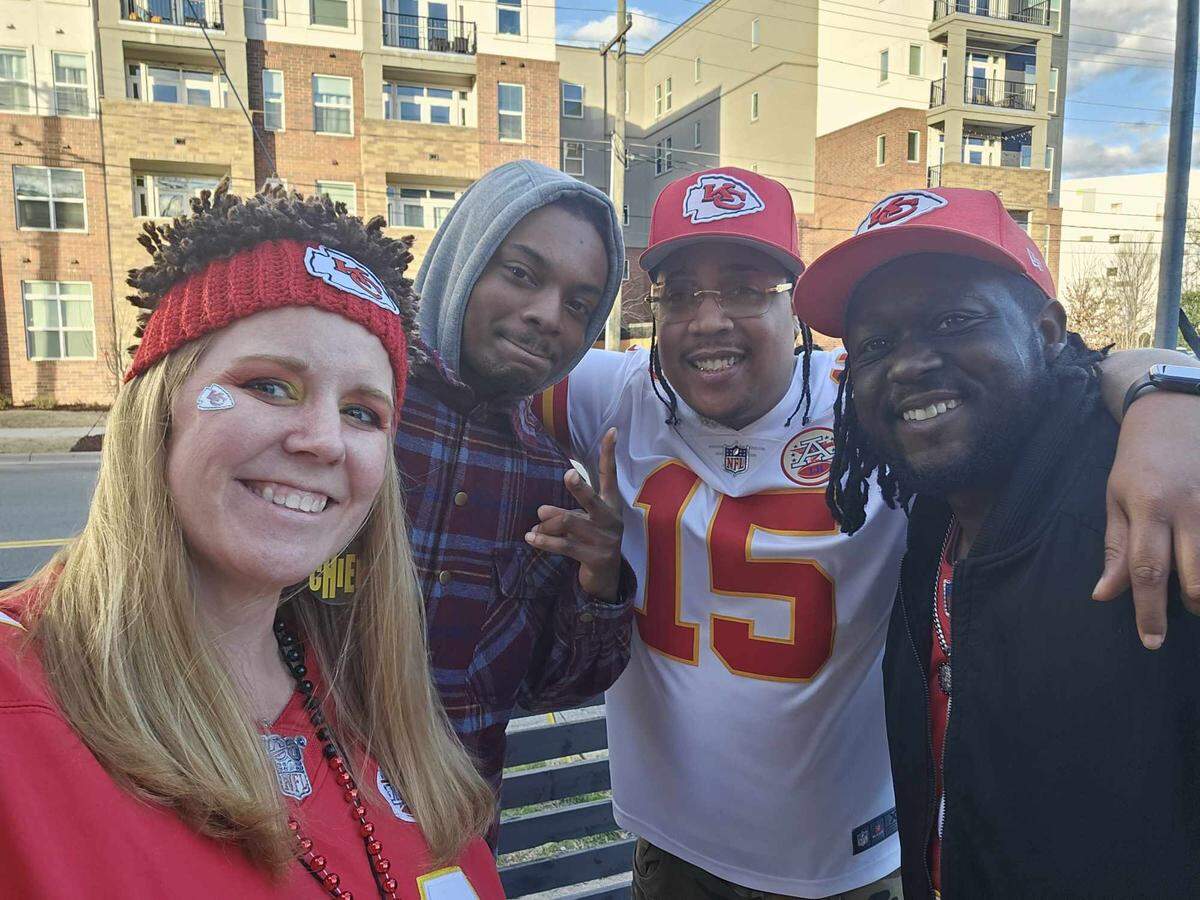 Kristen Bealler, an administrator of the Charlotte Chiefs Fans group, poses with fellow fans outside of Kilted Buffalo in Plaza Midwood.