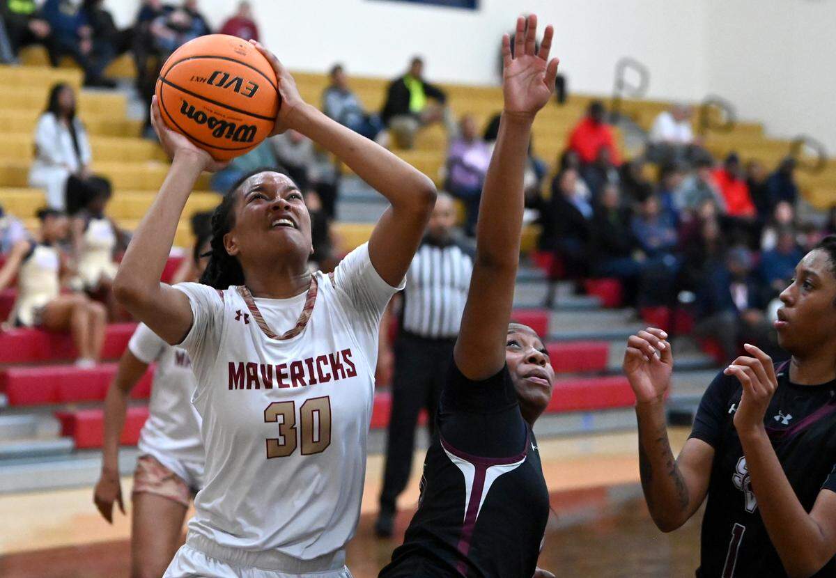 Mallard Creek’s Olivia Robertson, left, fights her way to the basket for a shot against the Sun Valley defense during action at Mallard Creek High School on Tuesday, February 27, 2024. Robertson’s father Eddie Robertson passed away two weeks ago and she has kept playing and dedicated her season to him.