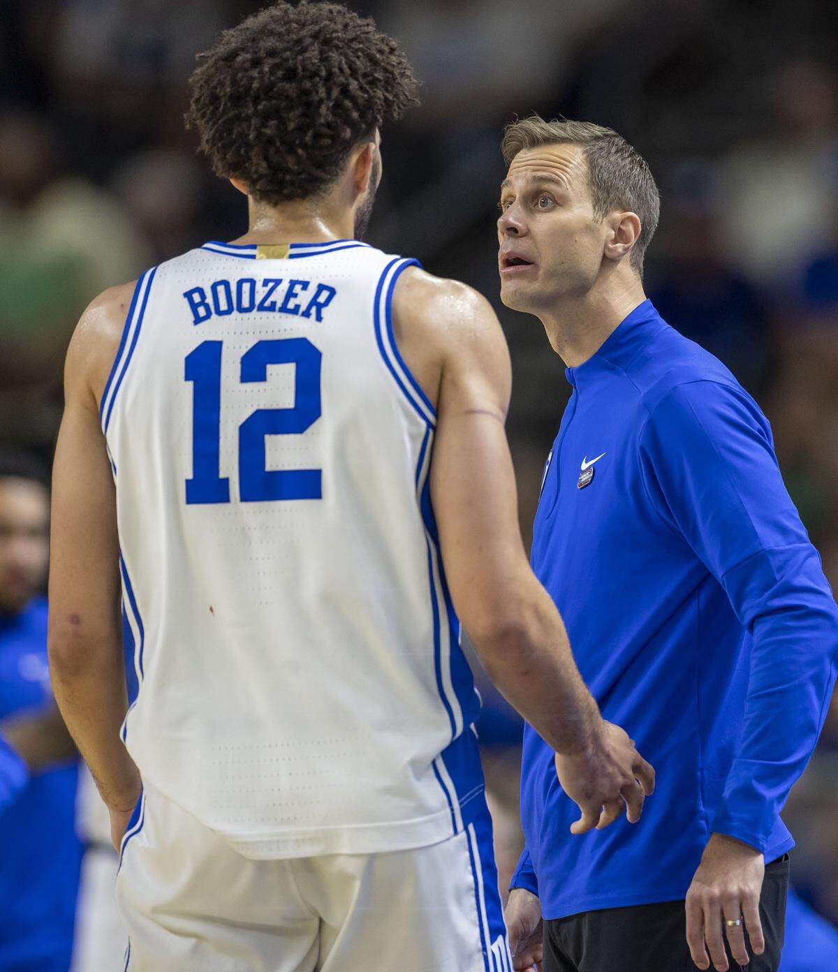 Duke coach Jon Scheyer talks with forward Cameron Boozer (12) in the first half against TCU Saturday. 