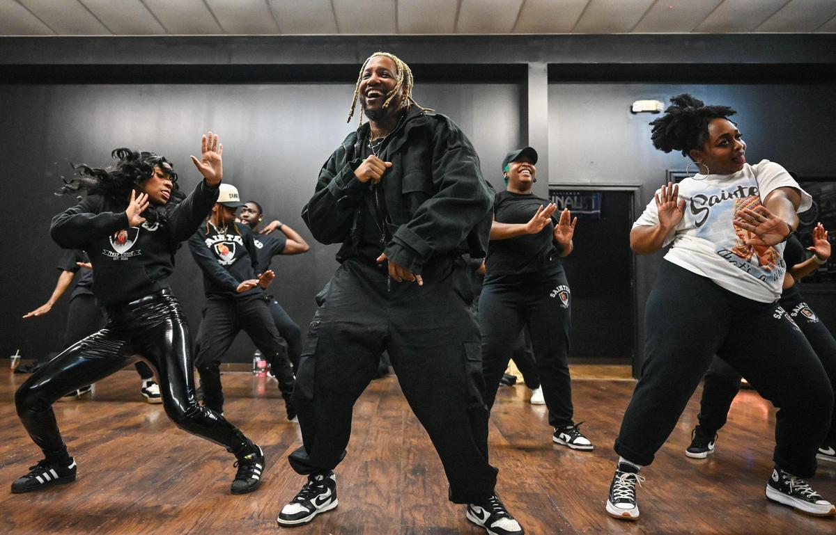 Dennis Reed Jr., center, rehearses with Sainted at a Charlotte dance studio last week. He co-founded the group — a “trap choir,” which performs an eclectic range of gospel, R&B, hip-hop and trap music — with DJ Fannie Mae.