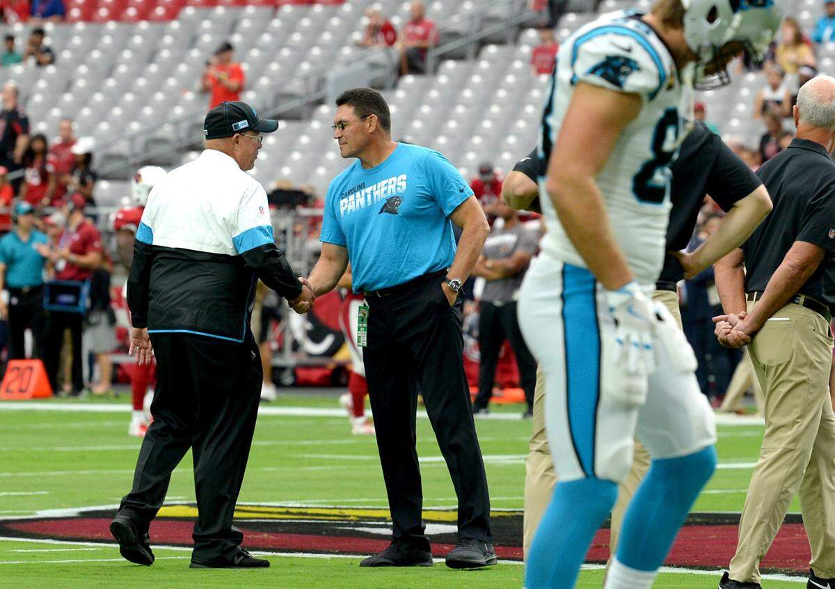 Carolina team owner David Tepper, left, shakes hands with head coach Ron Rivera prior to the Panthers’ game at Arizona on Sept. 22, 2019. Tepper fired Rivera less than three months later.