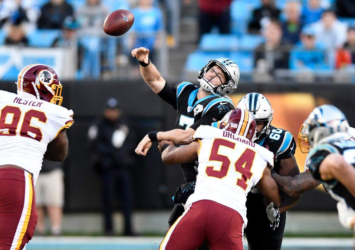 Carolina Panthers quarterback Kyle Allen (7) is hit as he throws against the Washington defense Sunday. Allen was sacked seven times in Washington’s 29-21 win.