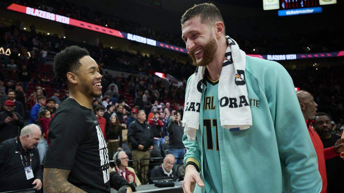 Charlotte Hornets center Jusuf Nurkic (11) greets Portland Trail Blazers guard Anfernee Simons (1) after a game at Moda Center.