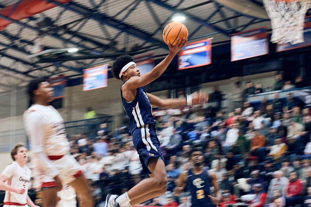 The Carmel Christian guard Logan Johnson(5) goes for the fast break layup in their 80-75 loss against Providence Day in the NCISAA state semifinals on February 24, 2026.