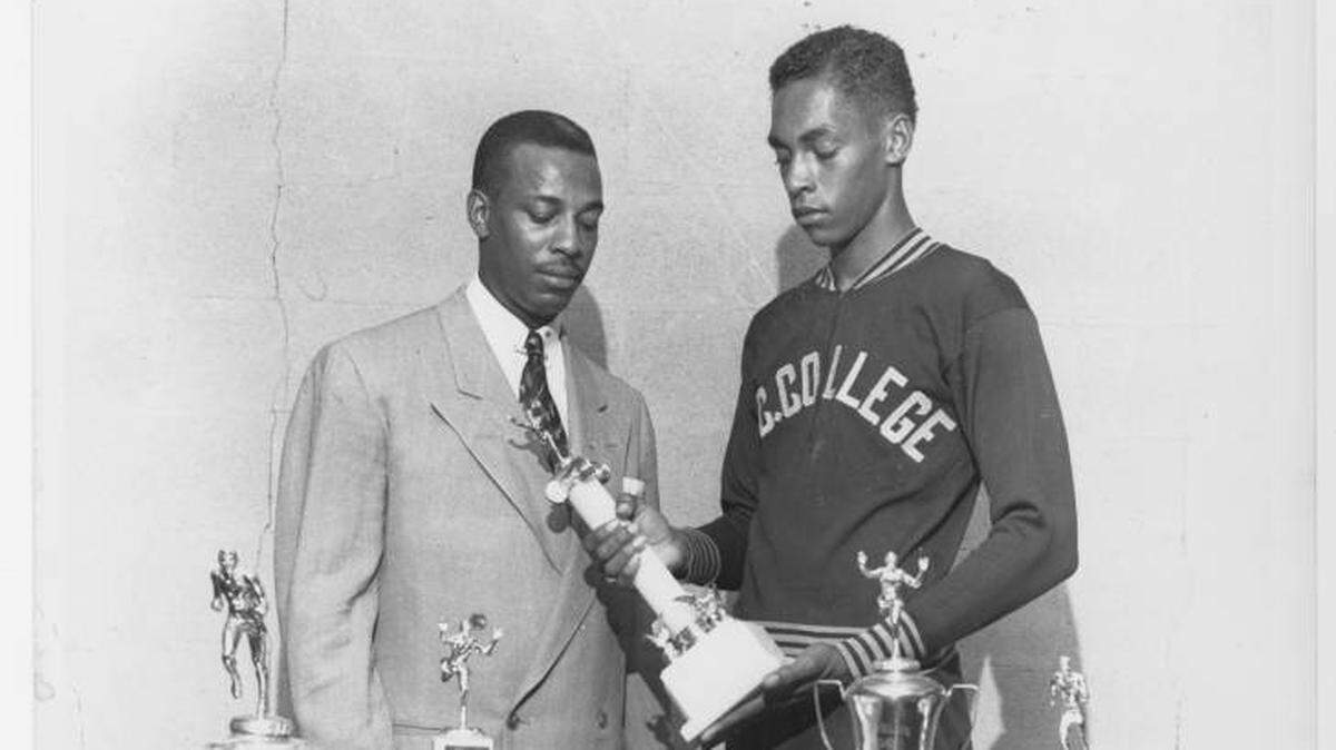 Former NC Central head track and field coach Leroy Walker (left) with athlete Lee Calhoun are pictured in 1957. At the time, the school was known as North Carolina College. Calhoun won the gold medal in the 110-meter hurdles at the 1956 Olympics and went on to capture the gold medal in the same event at the 1960 Olympics.